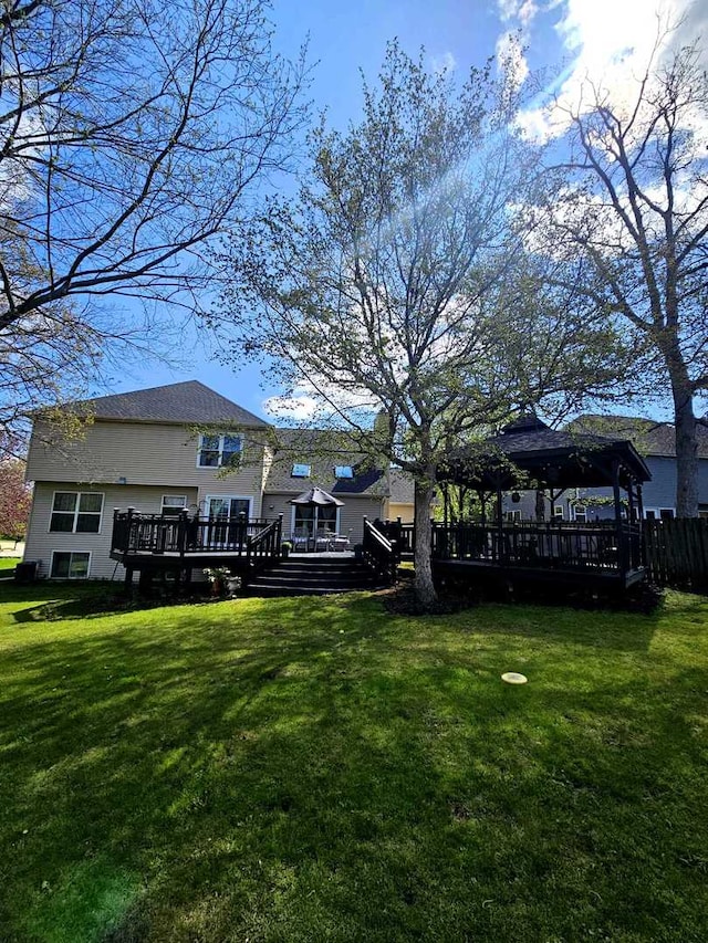 80 Chestnut Ct, Elgin, IL 60120 - back of property with a gazebo, a yard, and a deck