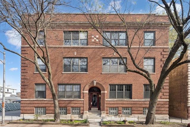 townhome / multi-family property featuring brick siding