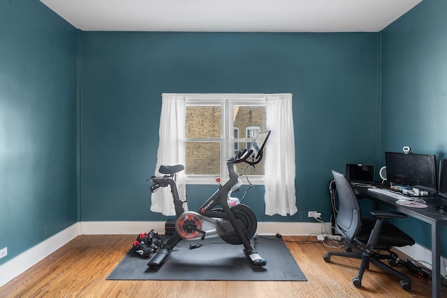 home office featuring baseboards and wood finished floors