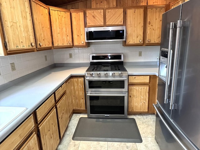 25-14 Country Hill Ct, Lake Carroll, IL 61046 - kitchen featuring stainless steel appliances, brown cabinetry, a sink, light countertops, and tasteful backsplash