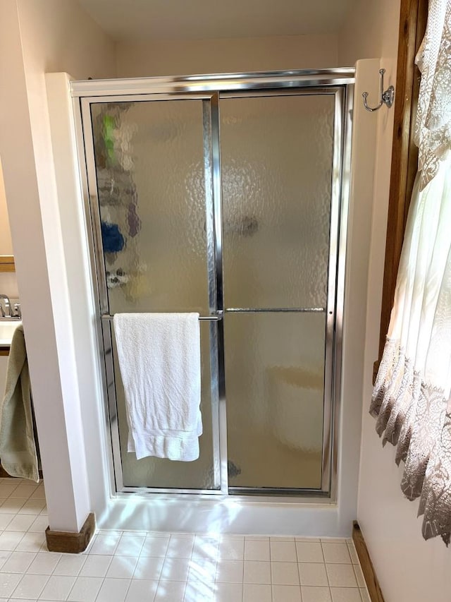 25-14 Country Hill Ct, Lake Carroll, IL 61046 - bathroom with tile patterned floors, baseboards, and a stall shower