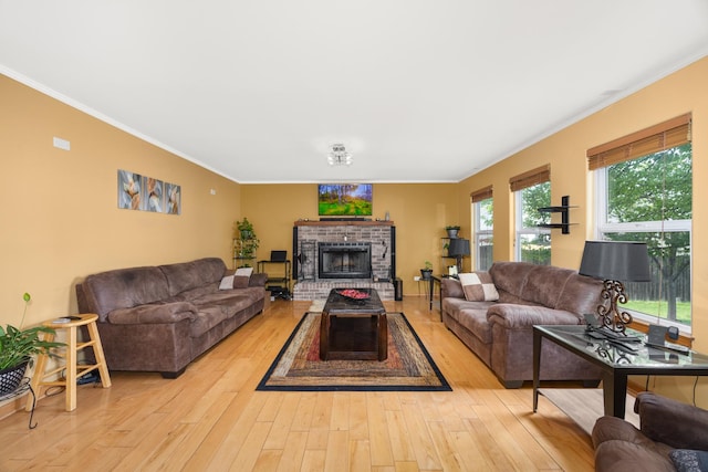 living room featuring crown molding, a brick fireplace, and wood-type flooring