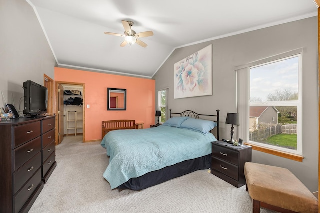 bedroom with crown molding, ceiling fan, light carpet, baseboards, and lofted ceiling