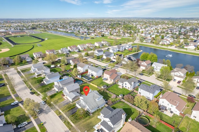 birds eye view of property featuring a residential view and a water view