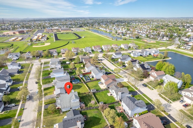 drone / aerial view featuring a water view and a residential view