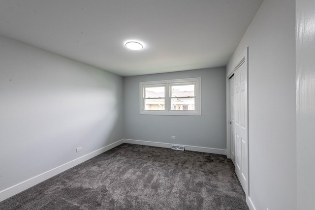 612 Thornwood Dr, South Holland, IL 60473 - unfurnished bedroom with baseboards, a closet, dark colored carpet, and visible vents