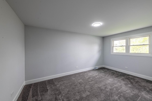 612 Thornwood Dr, South Holland, IL 60473 - empty room featuring dark colored carpet, baseboards, and visible vents