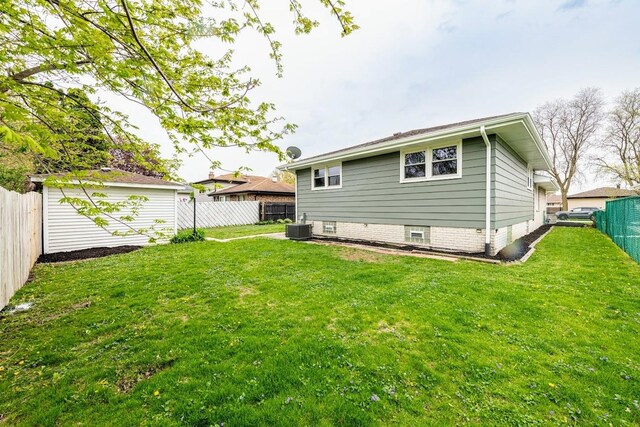 612 Thornwood Dr, South Holland, IL 60473 - rear view of house with a lawn, a fenced backyard, and central air condition unit