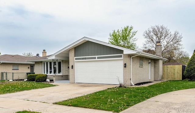 612 Thornwood Dr, South Holland, IL 60473 - view of front of property featuring brick siding, fence, a chimney, and a garage