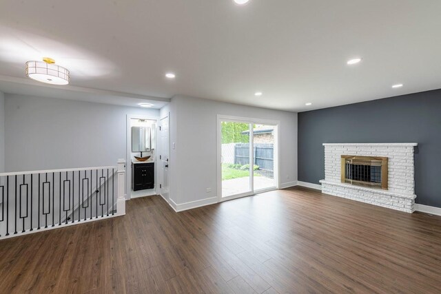 612 Thornwood Dr, South Holland, IL 60473 - unfurnished living room with dark wood-style flooring, baseboards, recessed lighting, and a fireplace