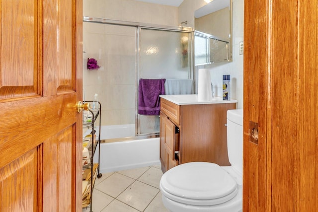 full bath featuring tile patterned flooring, combined bath / shower with glass door, toilet, and vanity