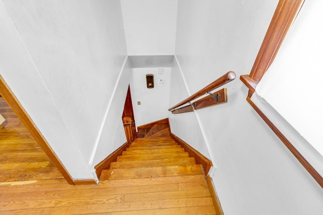 stairs featuring wood-type flooring and baseboards
