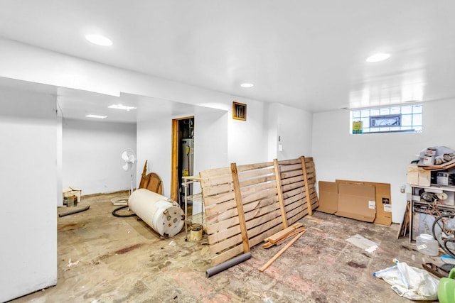 below grade area with gas water heater and recessed lighting