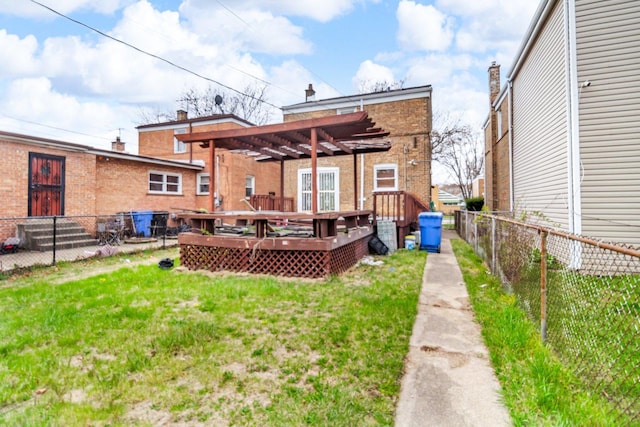 8619 S Jeffery Blvd, Chicago, IL 60617 - back of property featuring a wooden deck, a pergola, fence, brick siding, and a lawn