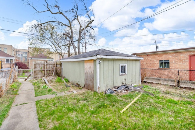 exterior space featuring a fenced backyard and an outdoor structure