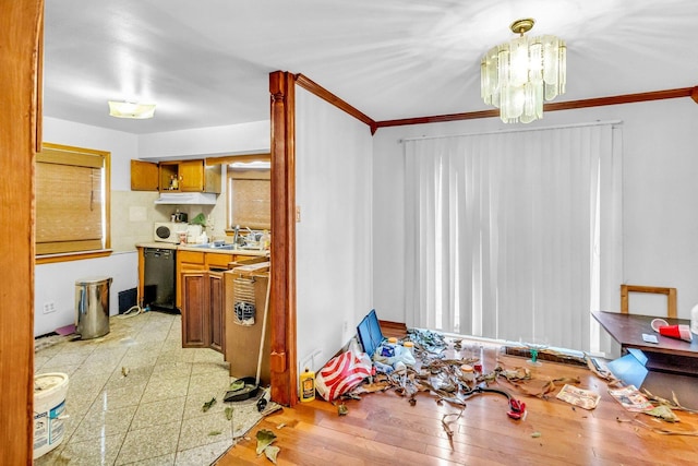 dining space with crown molding, light wood-style flooring, and a notable chandelier