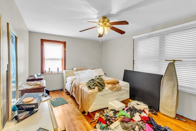 bedroom with ceiling fan and light wood finished floors