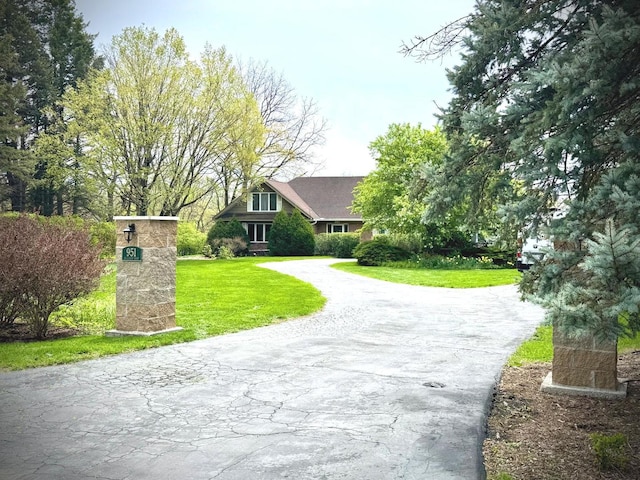 surrounding community with a yard and driveway