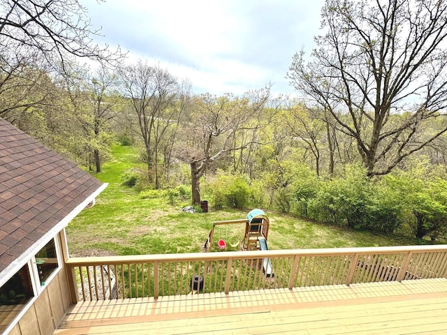 wooden terrace with a yard and a playground