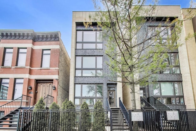 2423 W Haddon Ave Unit 2, Chicago, IL 60622 - view of building exterior featuring a fenced front yard and stairway
