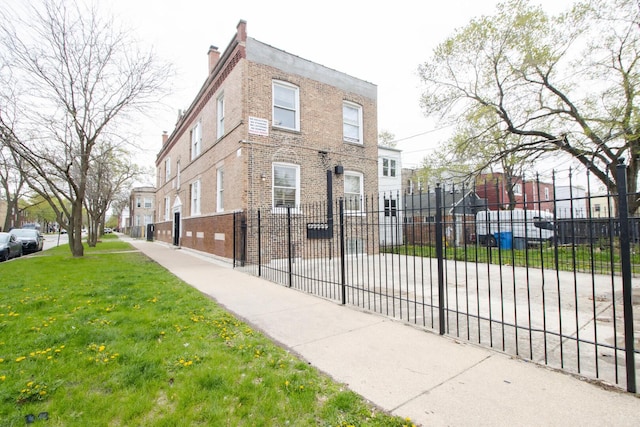exterior space featuring a yard, fence, and a residential view