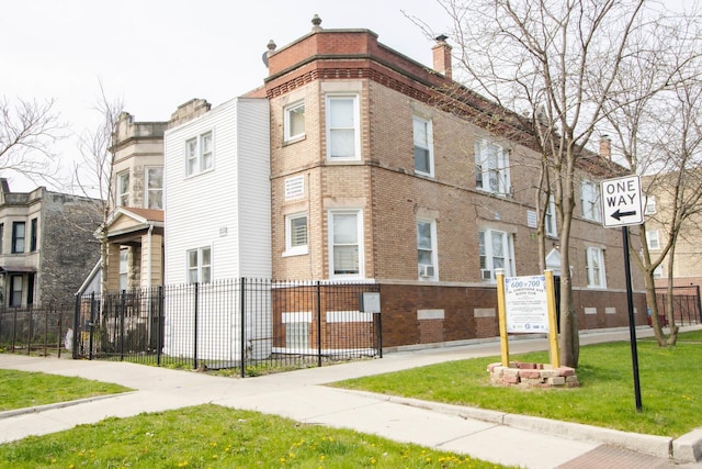 view of building exterior with fence