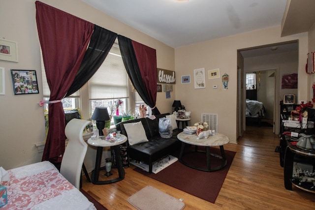 bedroom featuring visible vents and wood finished floors