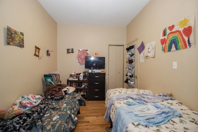 bedroom featuring a closet and light wood-style floors