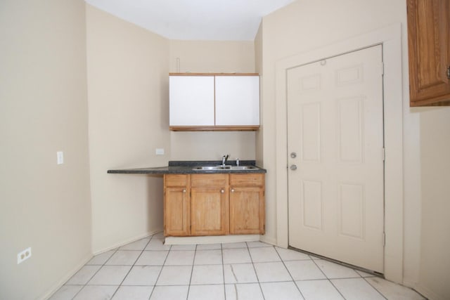 interior space featuring dark countertops, brown cabinetry, and a sink