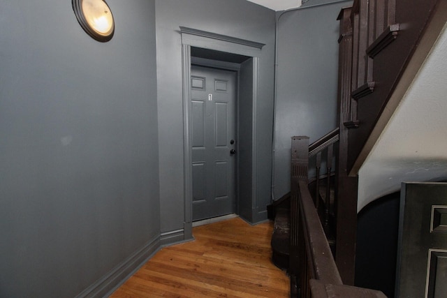 interior space featuring stairs, baseboards, and light wood-style flooring