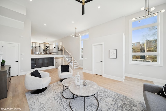living area with stairs, plenty of natural light, and light wood-style floors