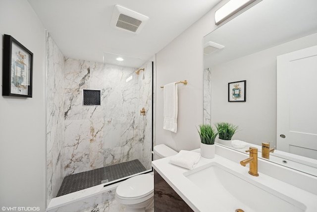 bathroom with visible vents, vanity, marble finish floor, toilet, and a marble finish shower