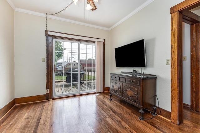 115 Van Buren St, Savanna, IL 61074 - living room featuring dark wood finished floors, crown molding, and baseboards