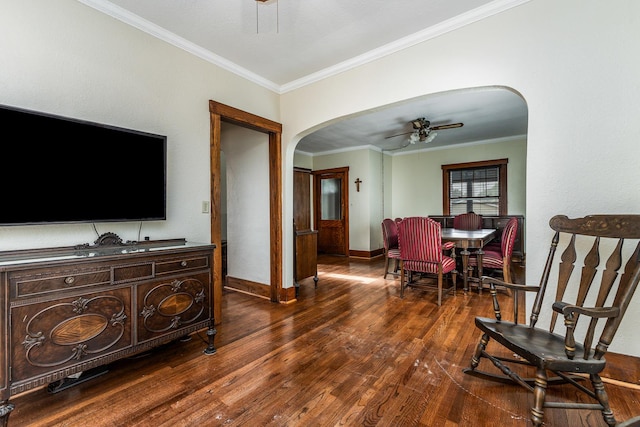115 Van Buren St, Savanna, IL 61074 - living room featuring arched walkways, ornamental molding, ceiling fan, dark wood-style flooring, and baseboards