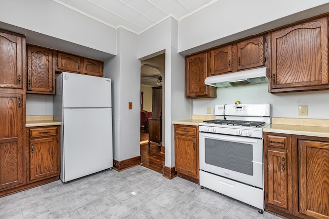 115 Van Buren St, Savanna, IL 61074 - kitchen featuring white appliances, under cabinet range hood, a ceiling fan, ornamental molding, and light countertops