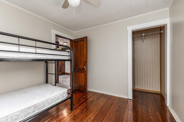 115 Van Buren St, Savanna, IL 61074 - unfurnished bedroom with hardwood / wood-style floors, crown molding, a ceiling fan, and baseboards