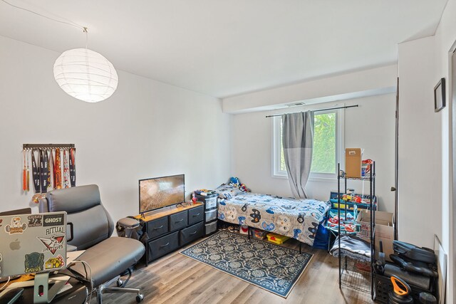 bedroom with wood finished floors