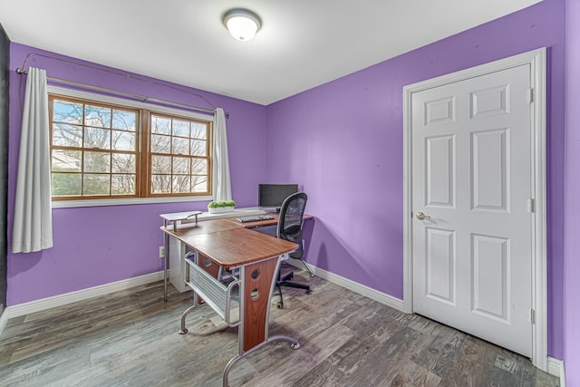 office space with baseboards and wood finished floors