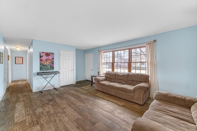 living room with baseboards and wood finished floors
