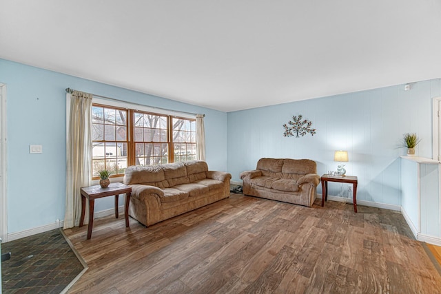 living area with baseboards and wood finished floors