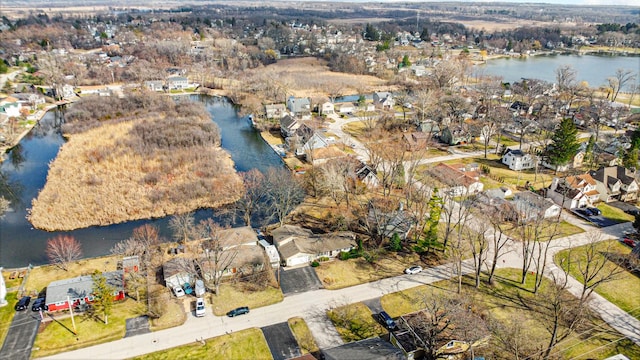 birds eye view of property featuring a water view and a residential view