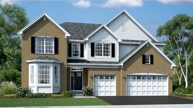 traditional-style house with brick siding, an attached garage, and aphalt driveway