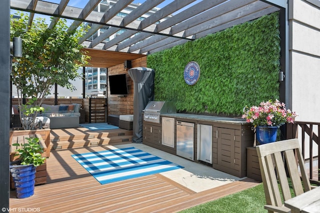 exterior space featuring a pergola, an outdoor kitchen, a deck, and area for grilling