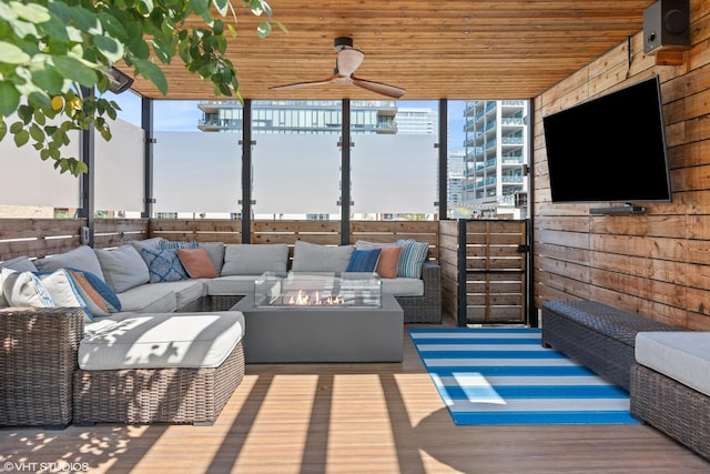 exterior space with an outdoor living space with a fire pit and ceiling fan