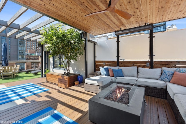 deck with a ceiling fan and an outdoor living space with a fire pit