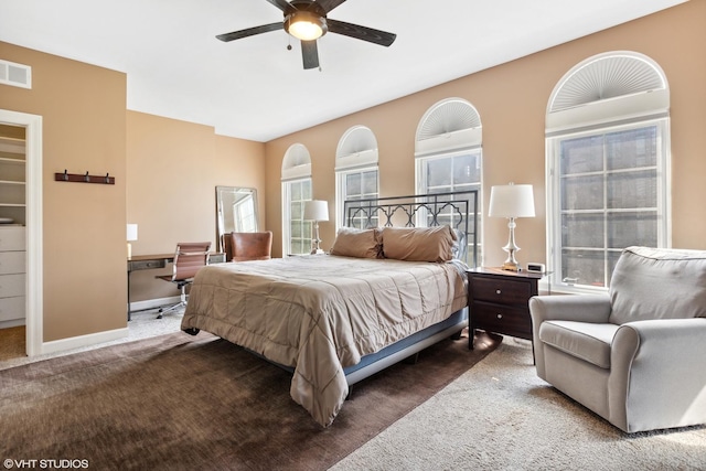 carpeted bedroom featuring a ceiling fan, baseboards, and visible vents