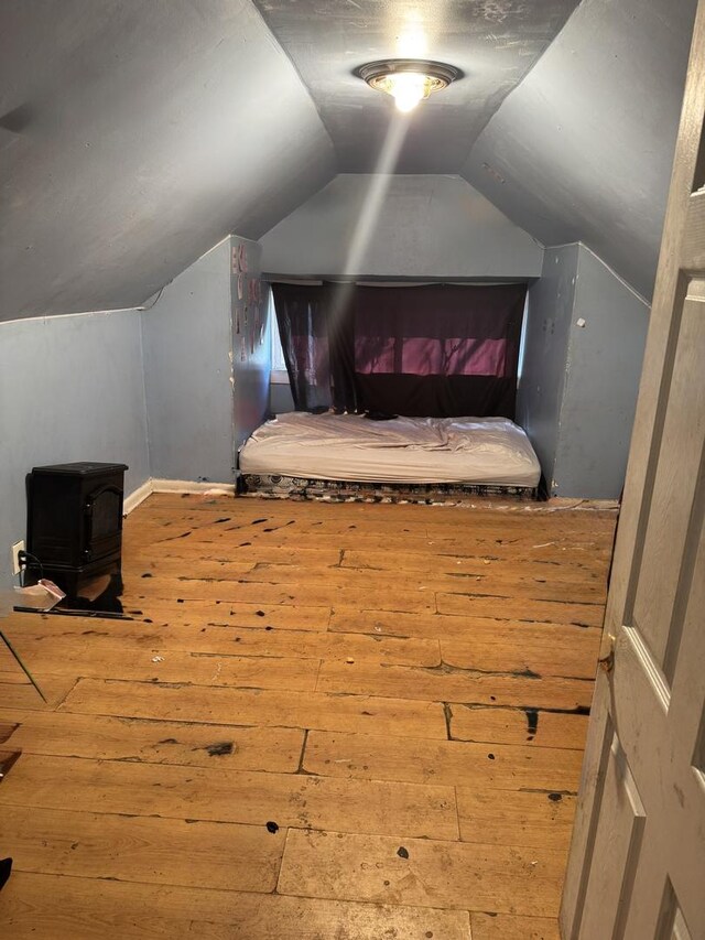 7328 S May St, Chicago, IL 60621 - bedroom with a wood stove, baseboards, vaulted ceiling, and hardwood / wood-style flooring