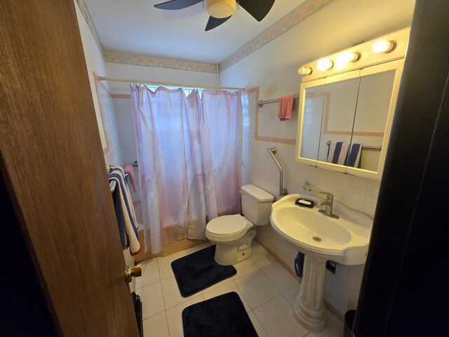 full bathroom with tile patterned flooring, a ceiling fan, toilet, tile walls, and a sink