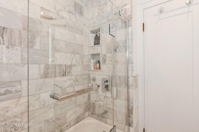 full bathroom with bath / shower combo with glass door