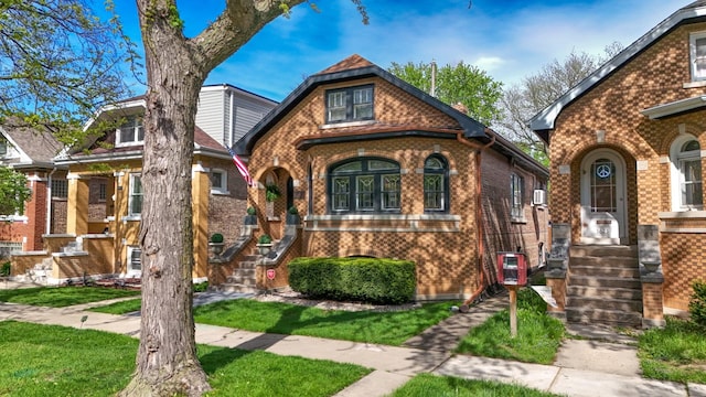 english style home with brick siding
